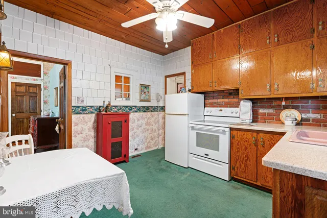 a bedroom with a bed dresser and a window