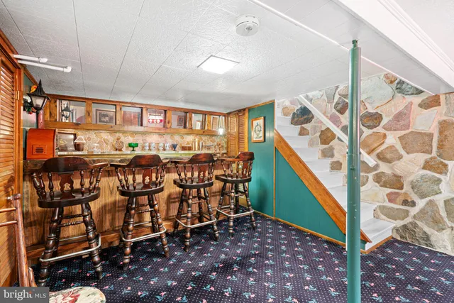 a view of a hallway to a livingroom with furniture