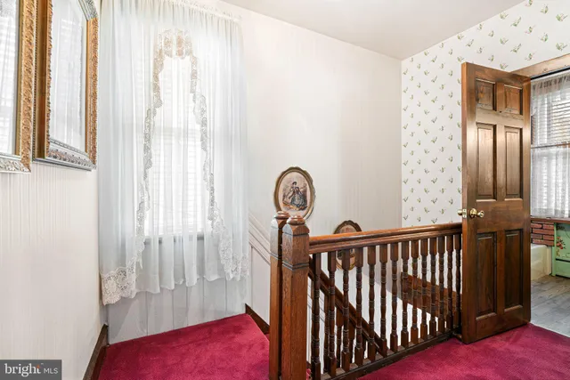 a bedroom with a bed a table and chair