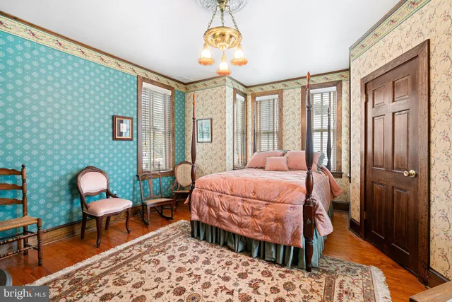 a living room with furniture and large windows