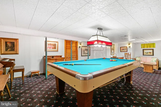 a room with pool table and window