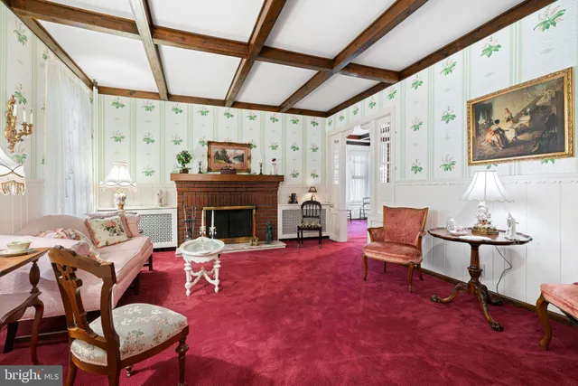 a living room with furniture and a dining table with wooden floor
