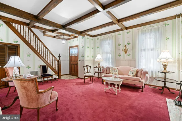 a living room with furniture a large window and chairs