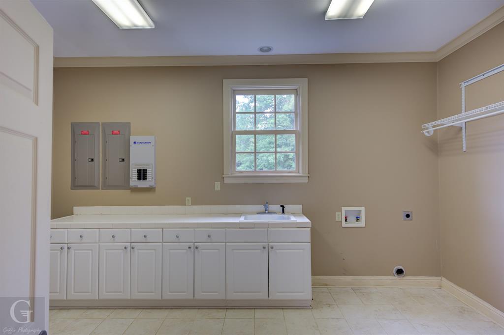 1212 WPA Road Homer, LA 71040 - Photo 24 of 35 Laundry area with electric dryer hookup, washer hookup, cabinet space, baseboards, and electric panel