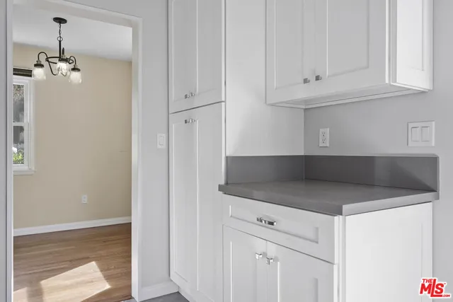 a kitchen with stainless steel appliances granite countertop white cabinets and a granite counter tops