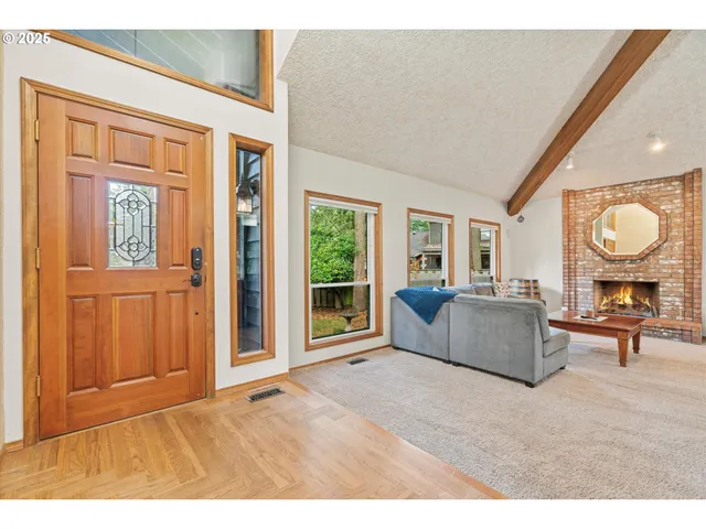 a living room with furniture a window and a potted plant