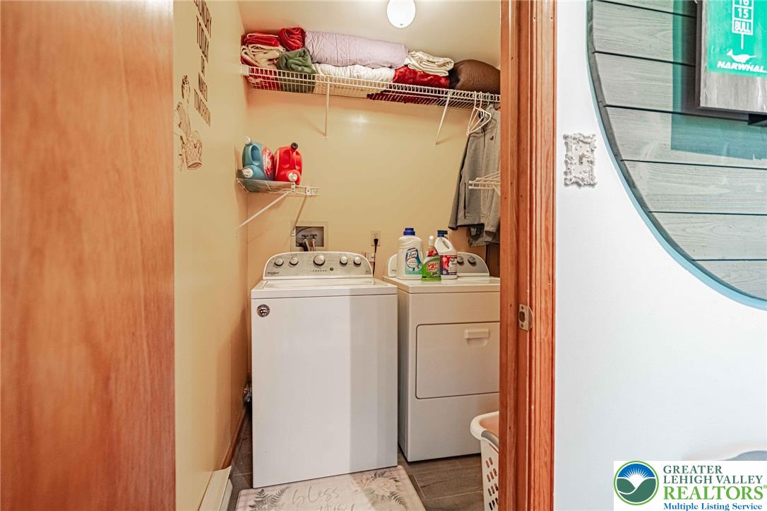 341 Lower Greenhill Road Kunkletown, PA 18058 - Photo 38 of 69 Lower level functional laundry space featuring convenient shelving for everyday chores.