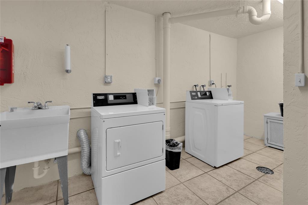 321 Southeast 3rd Street, Unit 307 Dania Beach, FL 33004 - Photo 16 of 21 a room with dryer and washer