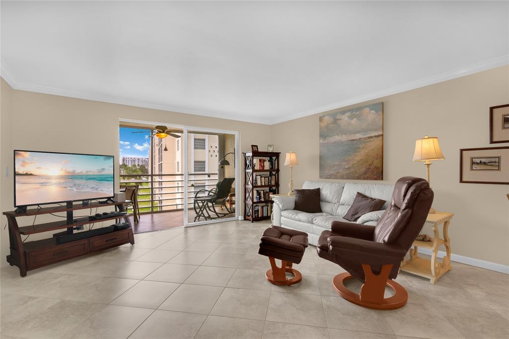 321 Southeast 3rd Street, Unit 307 Dania Beach, FL 33004 - Photo 7 of 21 a living room with furniture and a flat screen tv