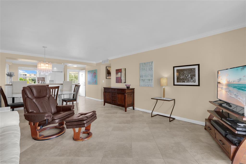 321 Southeast 3rd Street, Unit 307 Dania Beach, FL 33004 - Photo 8 of 21 a living room with furniture a flat screen tv and a fireplace