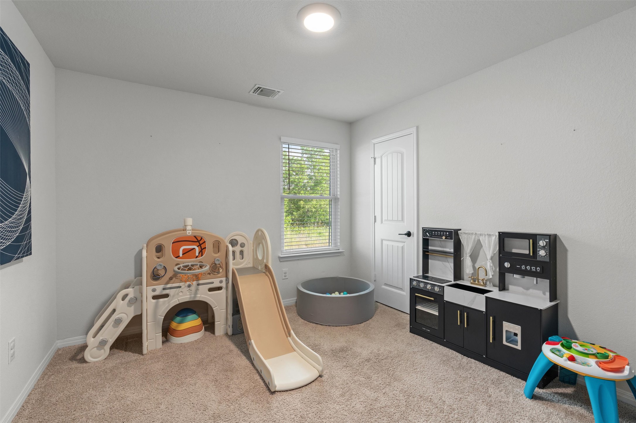 19912 Abigail Fillmore Road Manor, TX 78653 - Photo 19 of 31 A versatile room provides a comfortable space for play and relaxation.