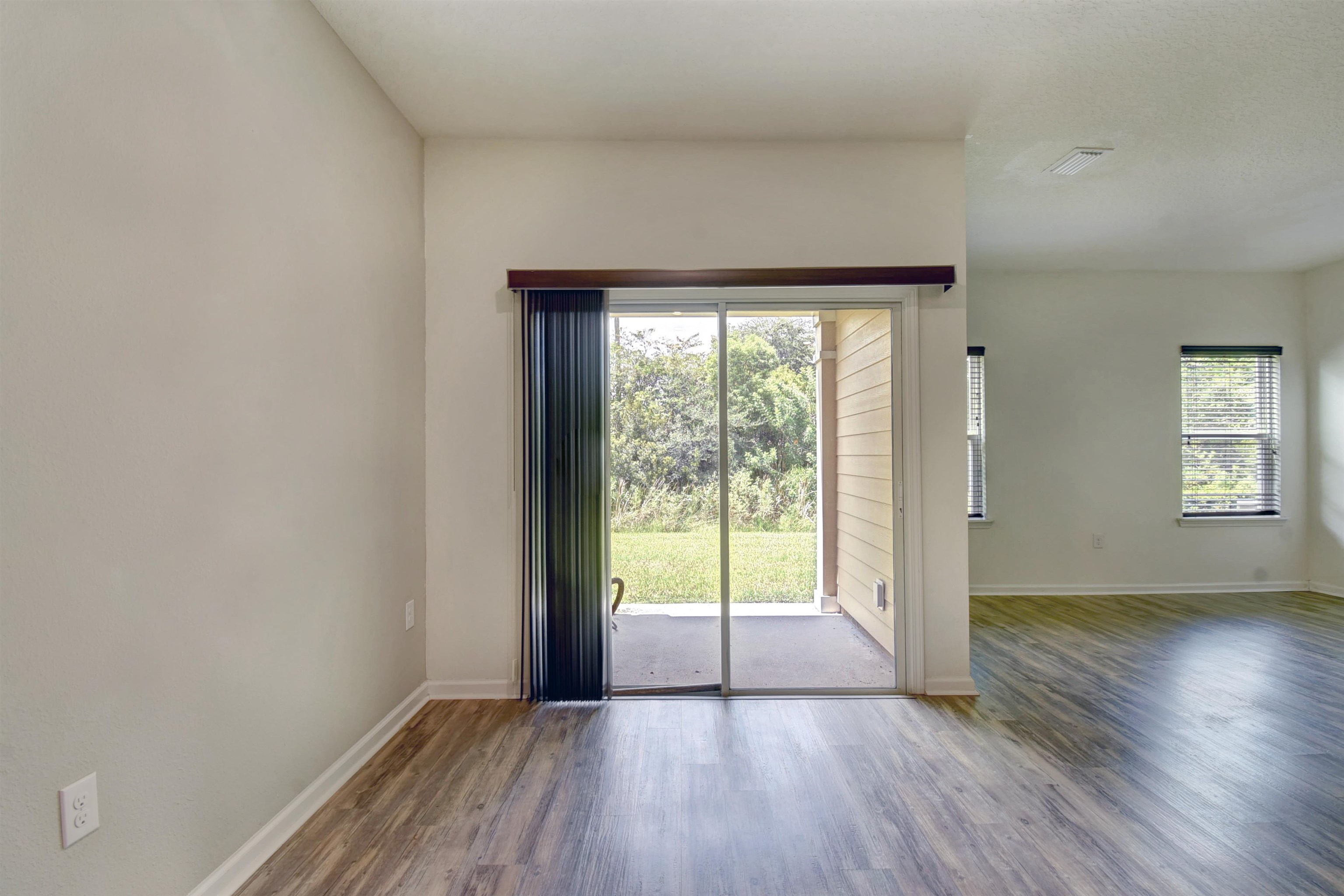 9 Bella Vita Way Ormond Beach, FL 32174 - Photo 12 of 36 a view of an empty room with wooden floor and a window