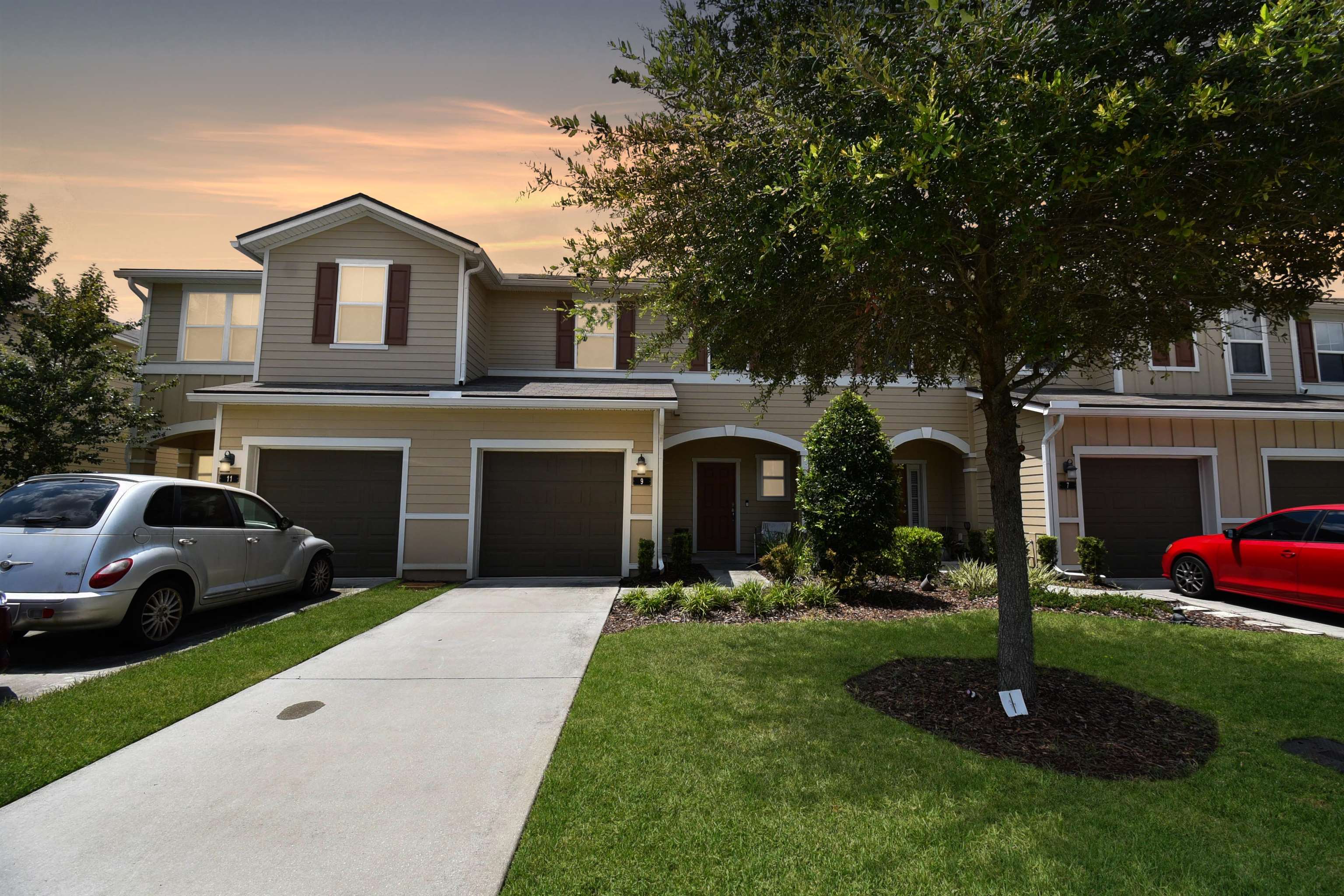 9 Bella Vita Way Ormond Beach, FL 32174 - Photo 34 of 36 a front view of a house with a garden and yard