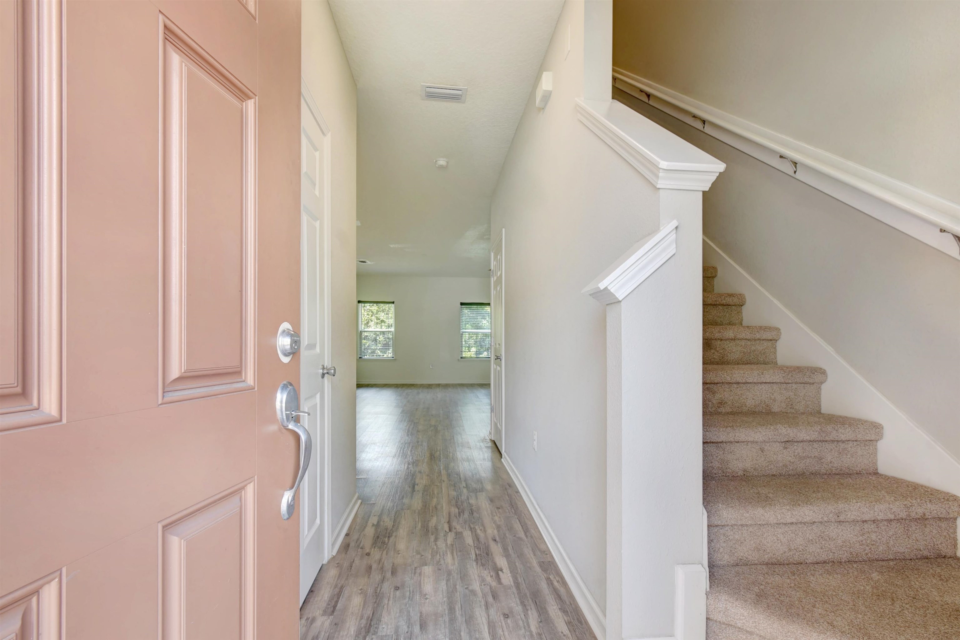 9 Bella Vita Way Ormond Beach, FL 32174 - Photo 4 of 36 a view of a hallway with wooden floor and staircase