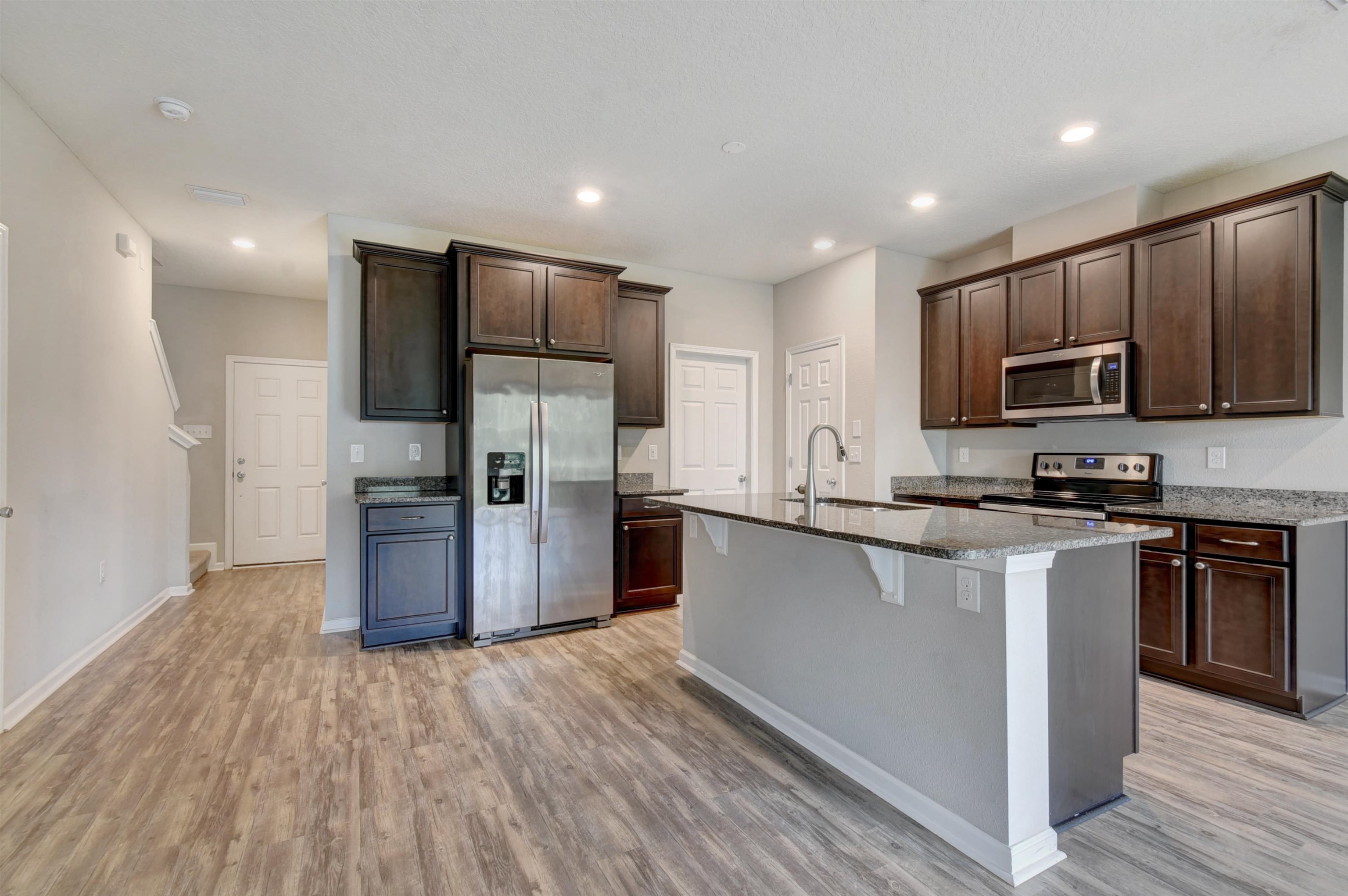 9 Bella Vita Way Ormond Beach, FL 32174 - Photo 5 of 36 a kitchen with stainless steel appliances granite countertop a refrigerator and a stove top oven