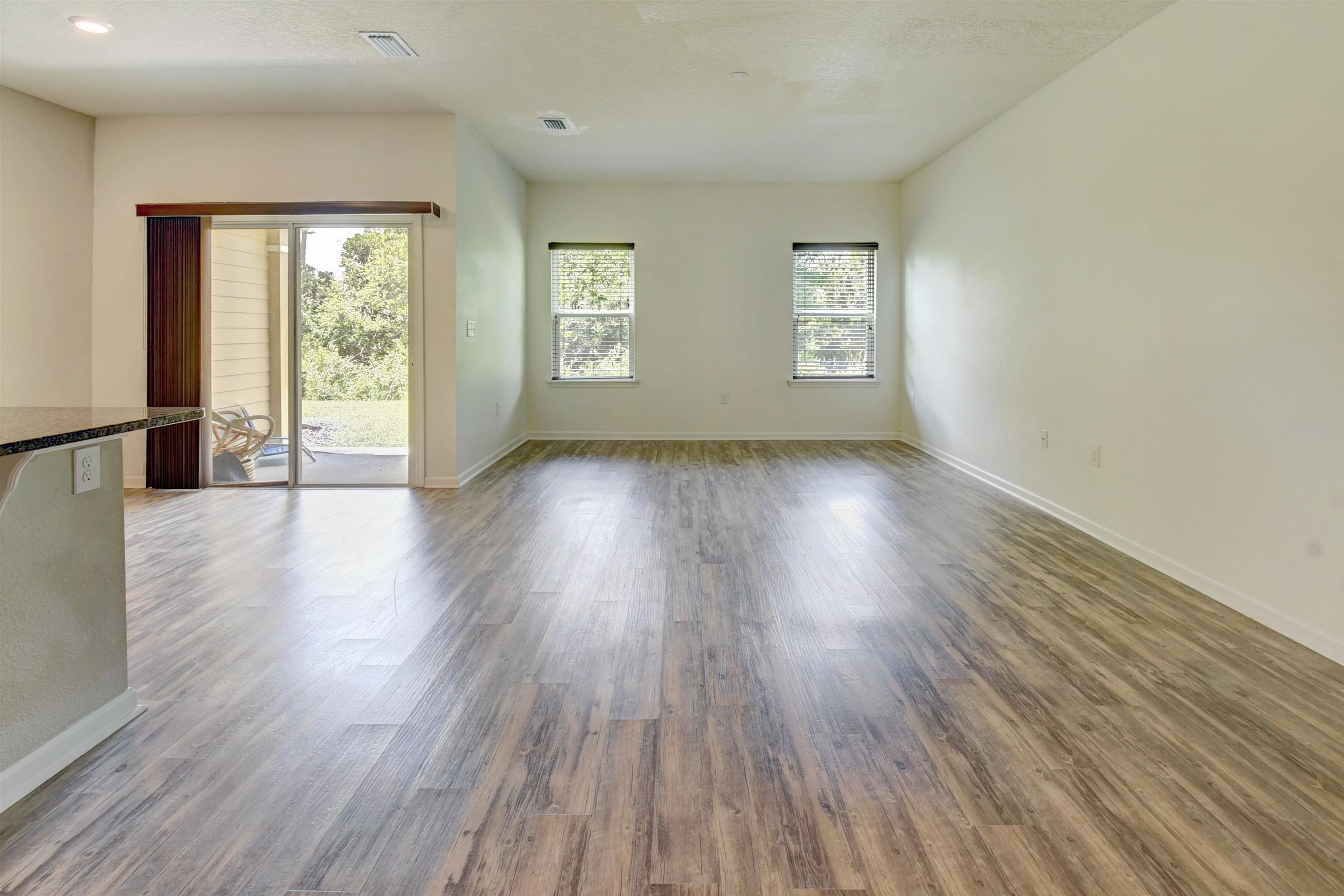 9 Bella Vita Way Ormond Beach, FL 32174 - Photo 10 of 36 an empty room with wooden floor and windows