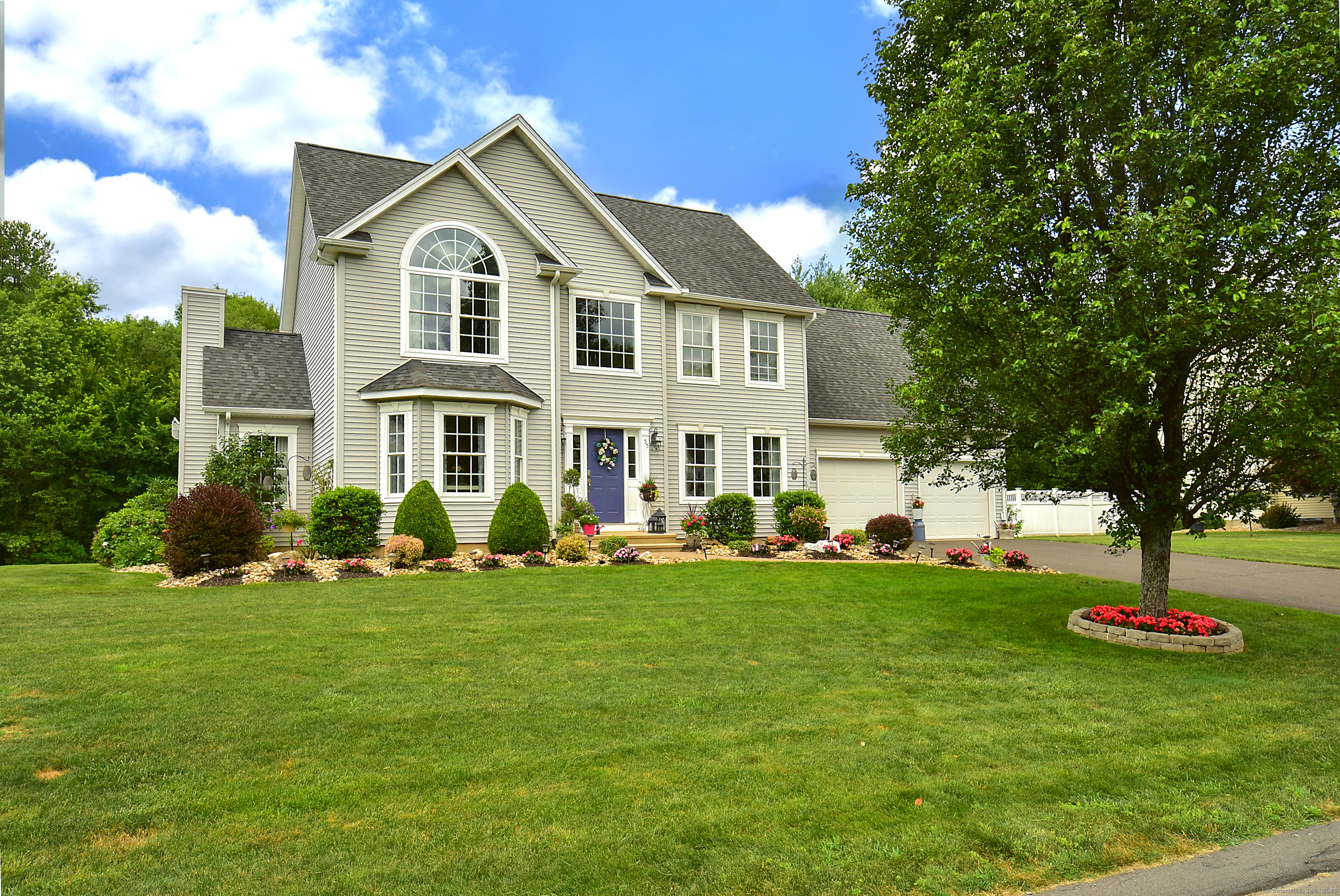 a front view of a house with a garden