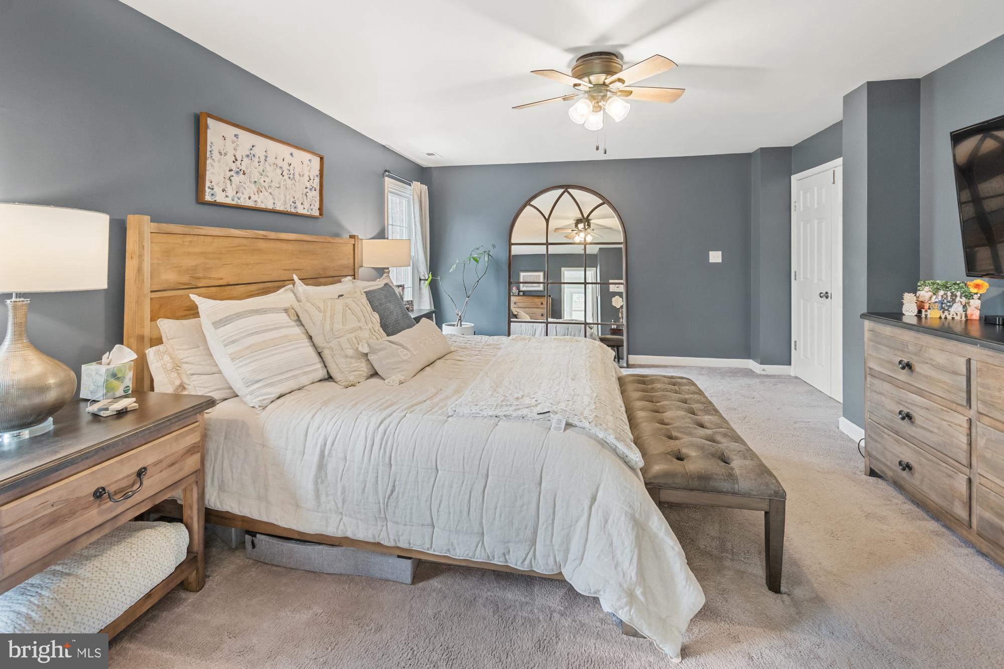 20008 Hickman Way Poolesville, MD 20837 - Photo 53 of 94 a bedroom with a bed and a chandelier