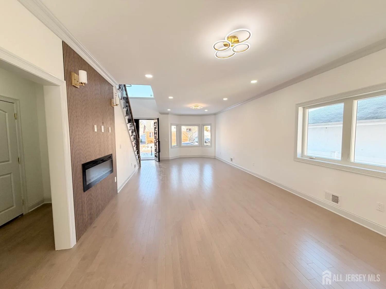 46 Foyer Street Edison, NJ 08817 - Photo 5 of 12 a view of a hallway with wooden floor and a fireplace