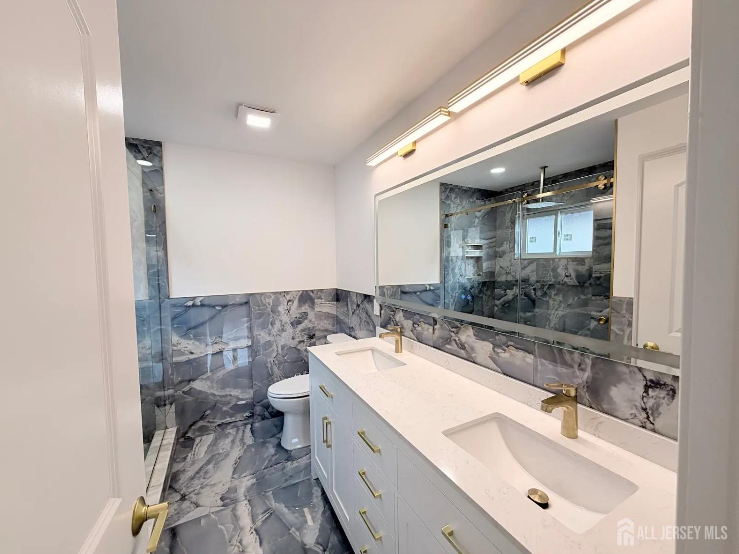 46 Foyer Street Edison, NJ 08817 - Photo 10 of 12 a bathroom with a double vanity sink mirror and toilet