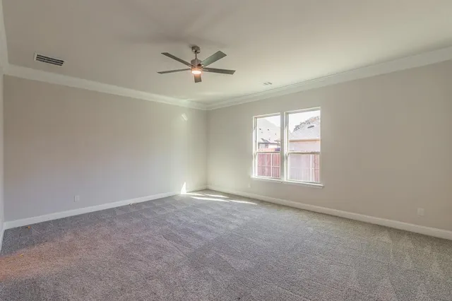 an empty room with closet and windows