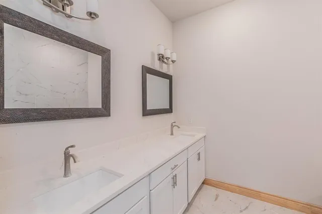 a white bath tub sitting next to a white toilet
