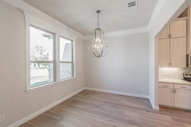 a view of a kitchen and an empty room
