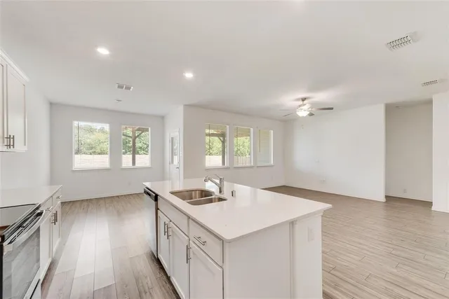 a kitchen with a sink stove and cabinets
