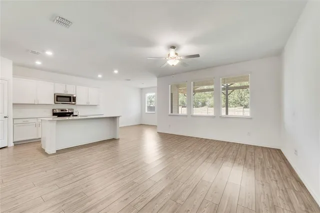 a view of kitchen with sink and wooden floor