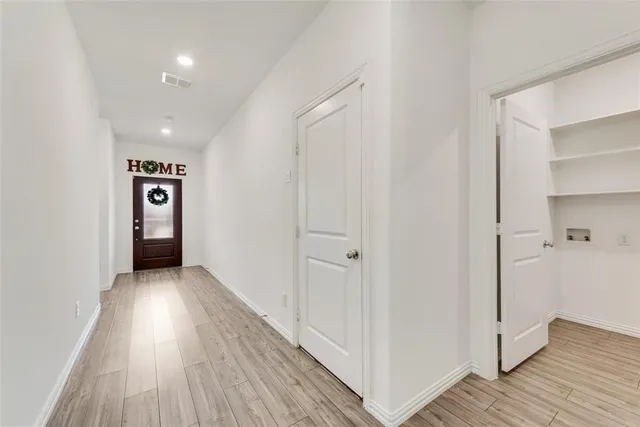 a view of a hallway with wooden floor