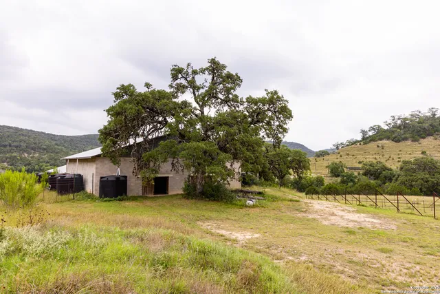 a yellow house with trees in front of it
