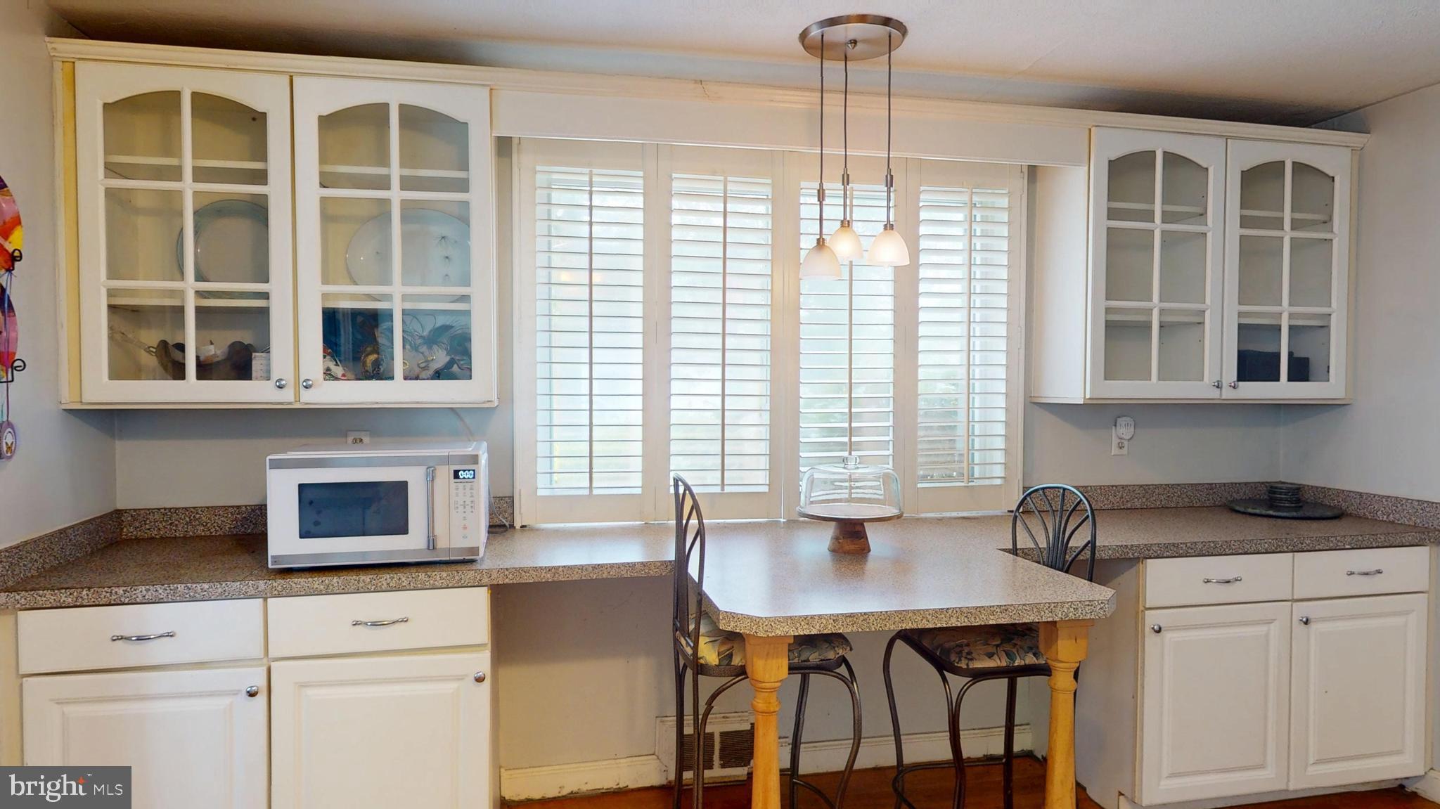 6103 Manor Road Clinton, MD 20735 - Photo 23 of 48 a kitchen with a table chairs and microwave