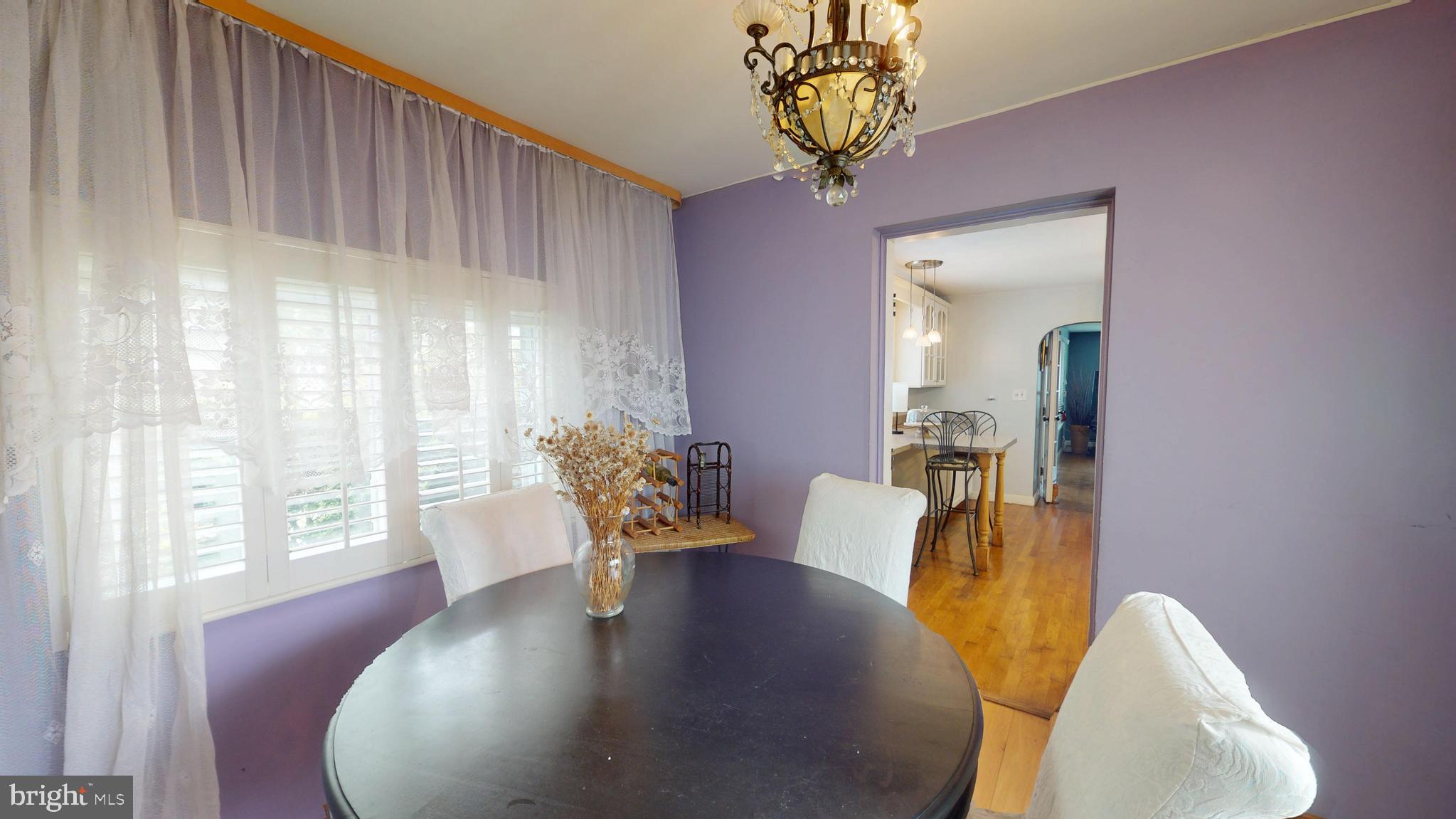 6103 Manor Road Clinton, MD 20735 - Photo 25 of 48 a view of a dining room with furniture and wooden floor