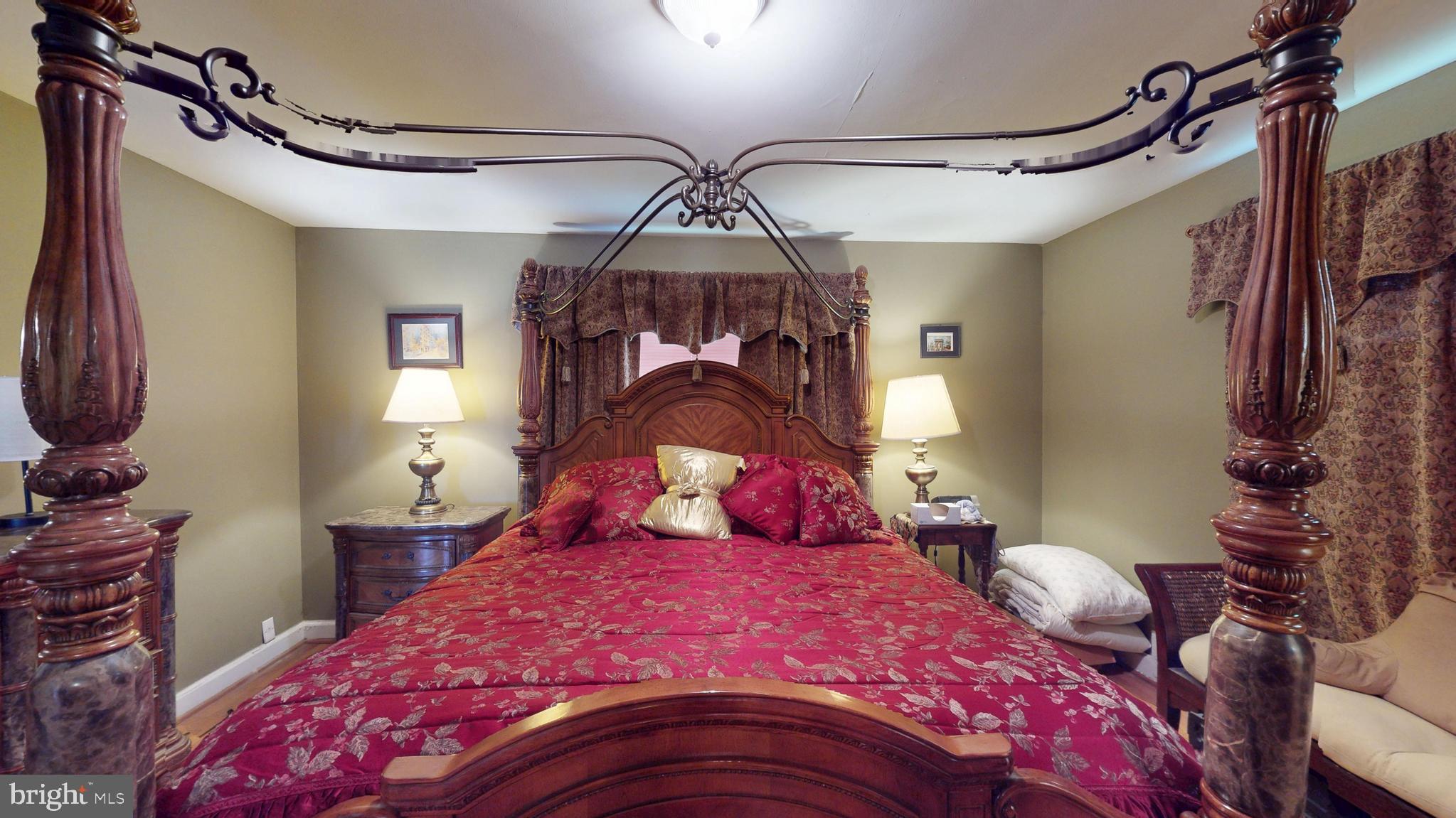 6103 Manor Road Clinton, MD 20735 - Photo 29 of 48 a bedroom with a bed and a chandelier