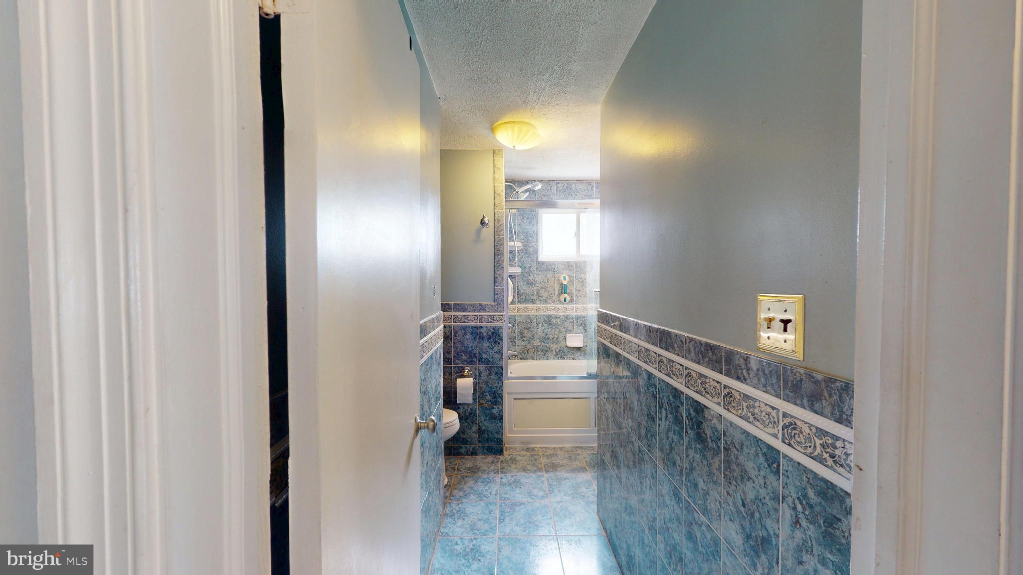 6103 Manor Road Clinton, MD 20735 - Photo 33 of 48 a bathroom with a mirror and a shower