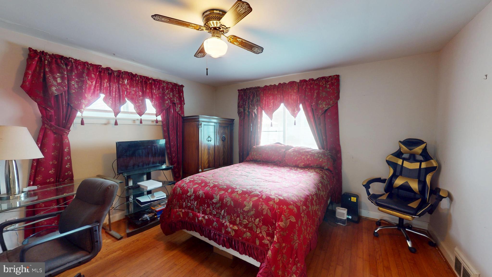 6103 Manor Road Clinton, MD 20735 - Photo 35 of 48 a bedroom with a bed and wooden floor