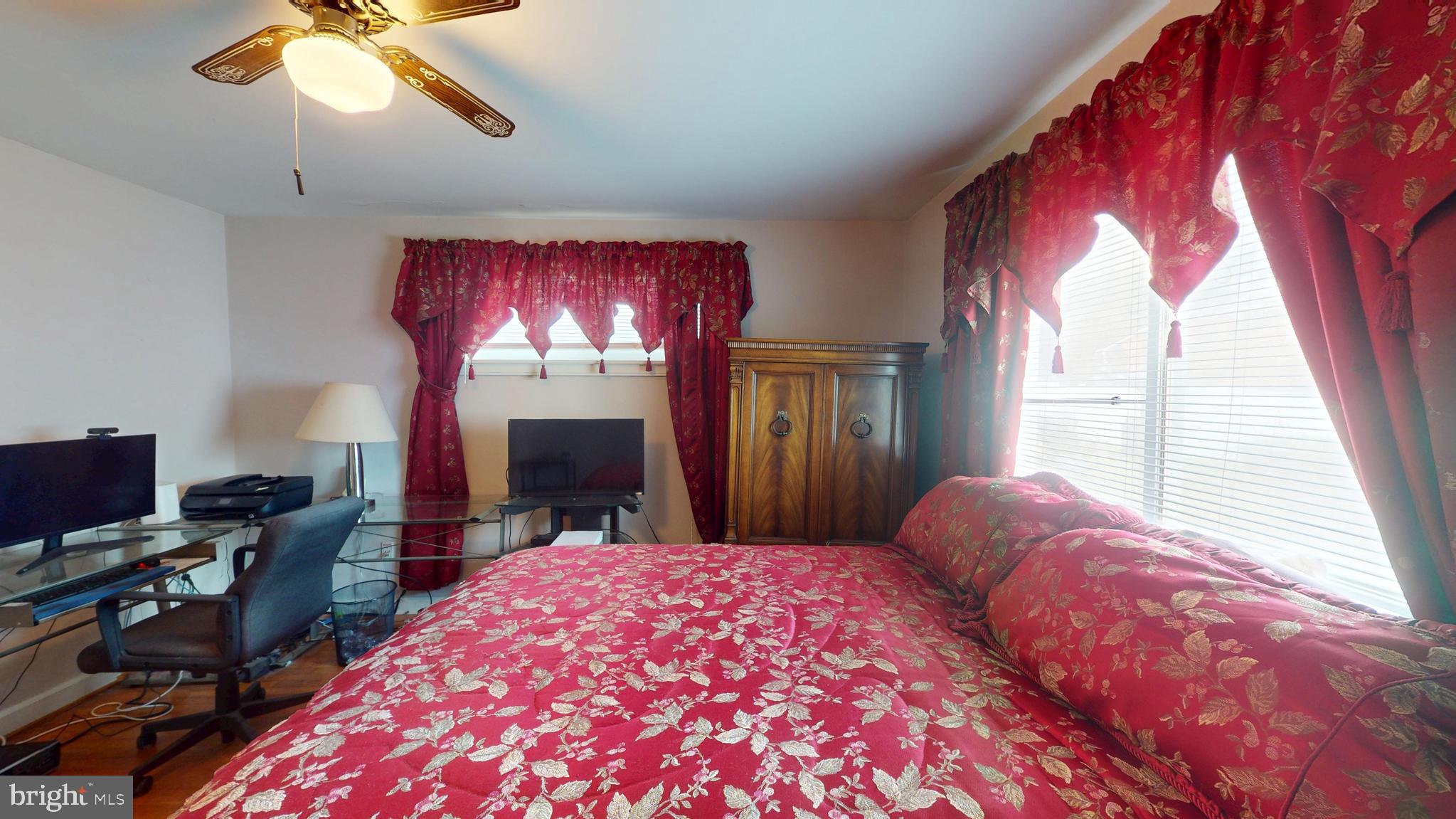 6103 Manor Road Clinton, MD 20735 - Photo 37 of 48 a bed room with a bed mirror and a window