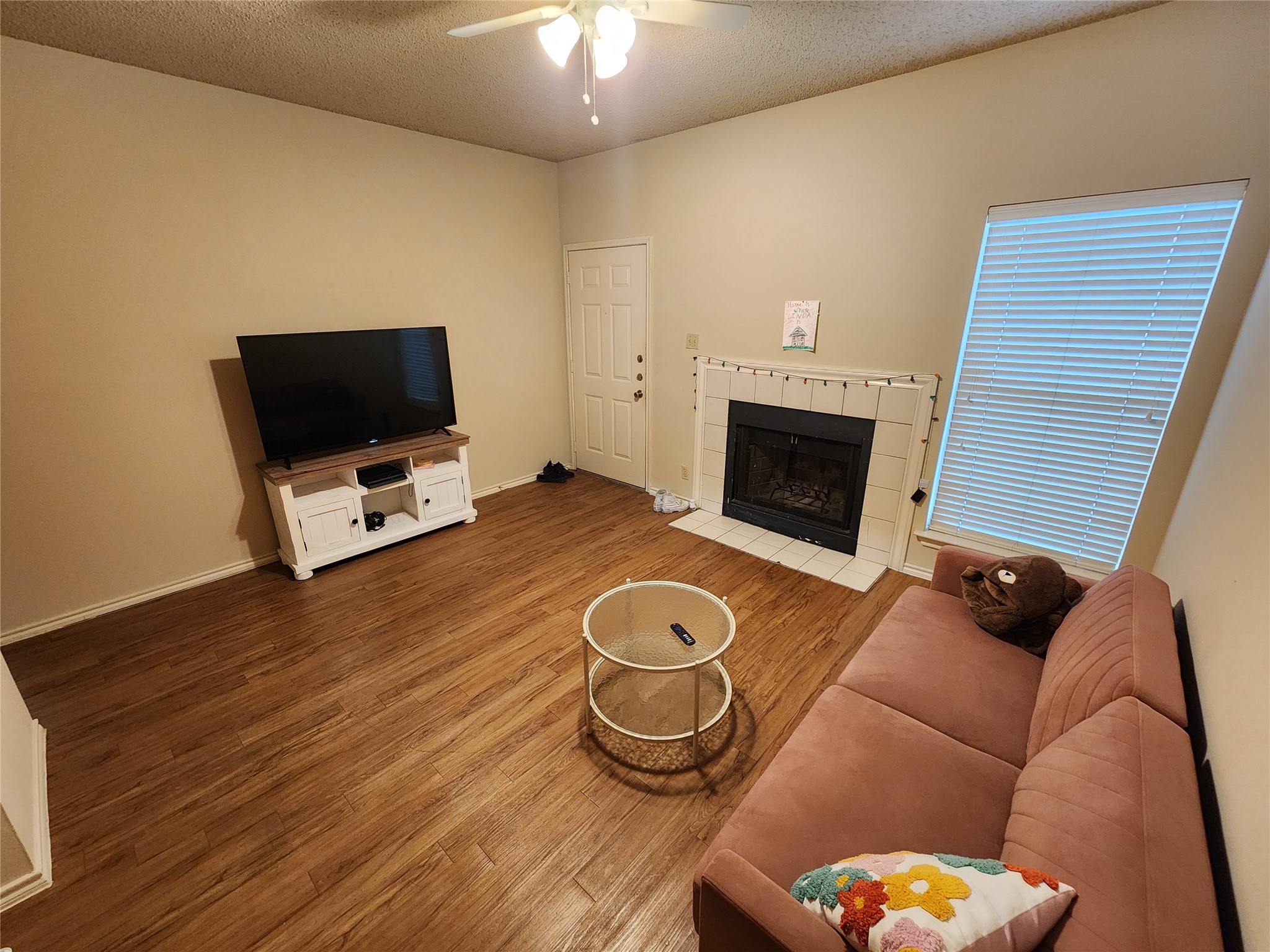 a living room with furniture a fireplace and a flat screen tv
