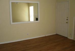 2414 Longview Street, Unit 306 Austin, TX 78705 - Photo 11 of 14 an empty room with wooden floor and windows