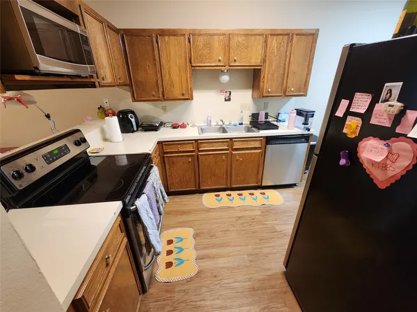 a kitchen with a sink a stove and refrigerator