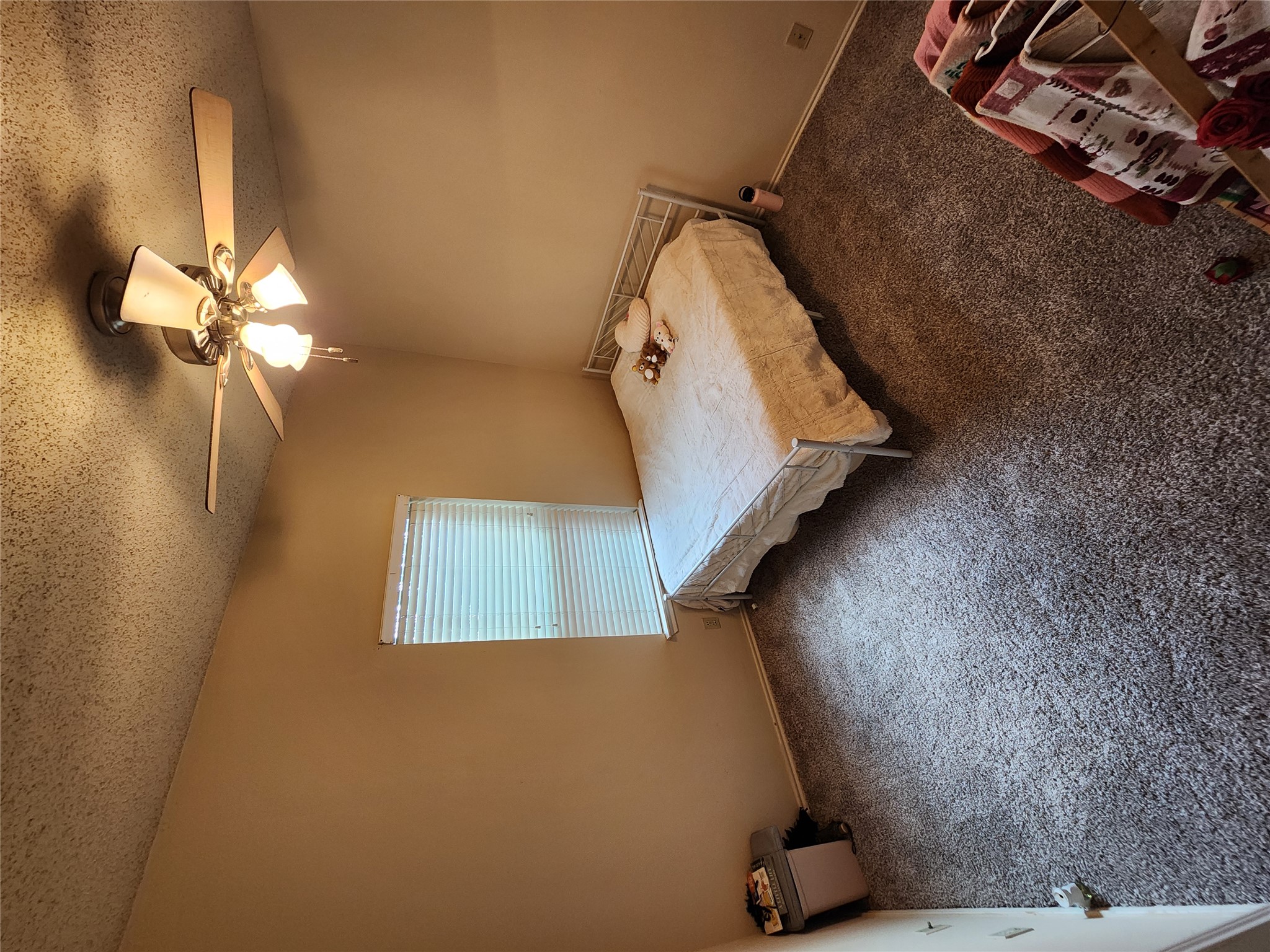 2414 Longview Street, Unit 306 Austin, TX 78705 - Photo 4 of 14 a bedroom with a bed and a chandelier