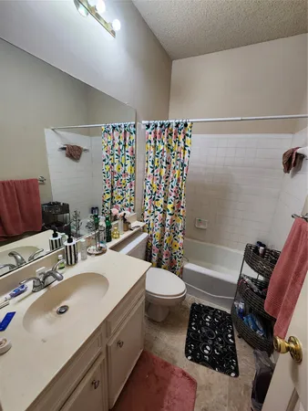 a bathroom with a sink toilet tub and shower