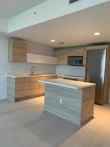 a kitchen with kitchen countertops and cabinets