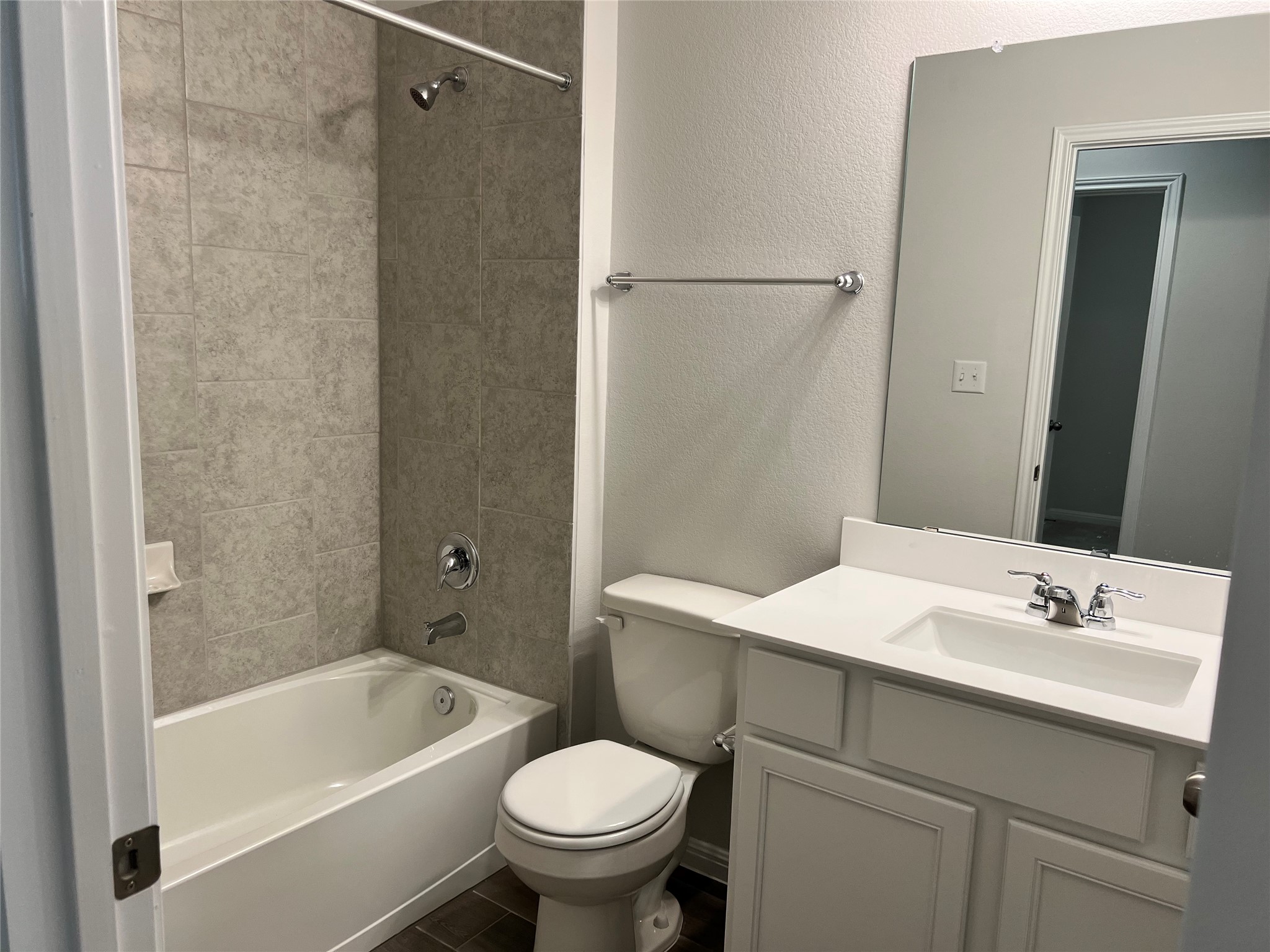 140 Pentro Path Georgetown, TX 78626 - Photo 13 of 37 A well-appointed bathroom features a combined tub and shower, alongside a neat vanity with ample counter space.