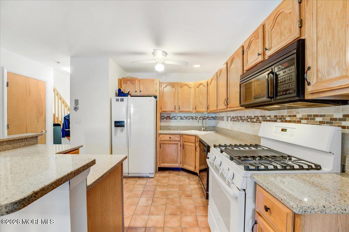 46 Stony Hill Road Jamesburg, NJ 08831 - Photo 12 of 23 a kitchen with a stove a sink and a refrigerator