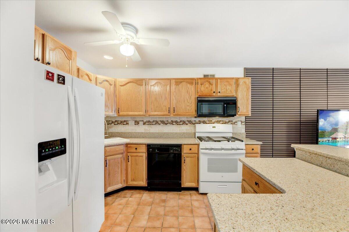 46 Stony Hill Road Jamesburg, NJ 08831 - Photo 13 of 23 a kitchen with stainless steel appliances a stove sink and microwave