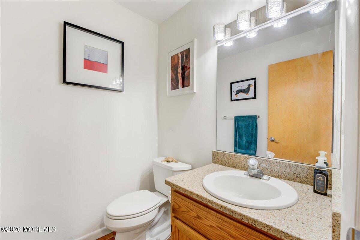 46 Stony Hill Road Jamesburg, NJ 08831 - Photo 14 of 23 a bathroom with a toilet a sink and mirror