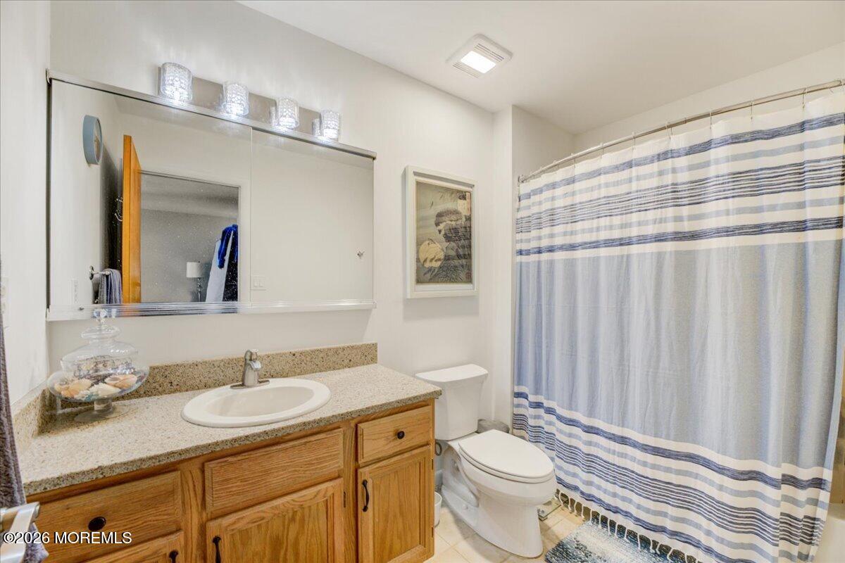 46 Stony Hill Road Jamesburg, NJ 08831 - Photo 20 of 23 a bathroom with a granite countertop sink toilet and mirror