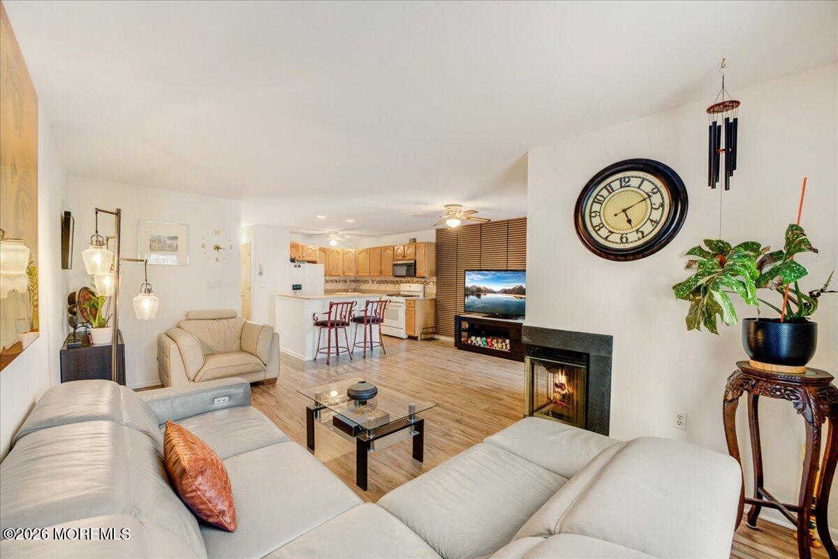 46 Stony Hill Road Jamesburg, NJ 08831 - Photo 8 of 23 a living room with furniture a clock and a fireplace