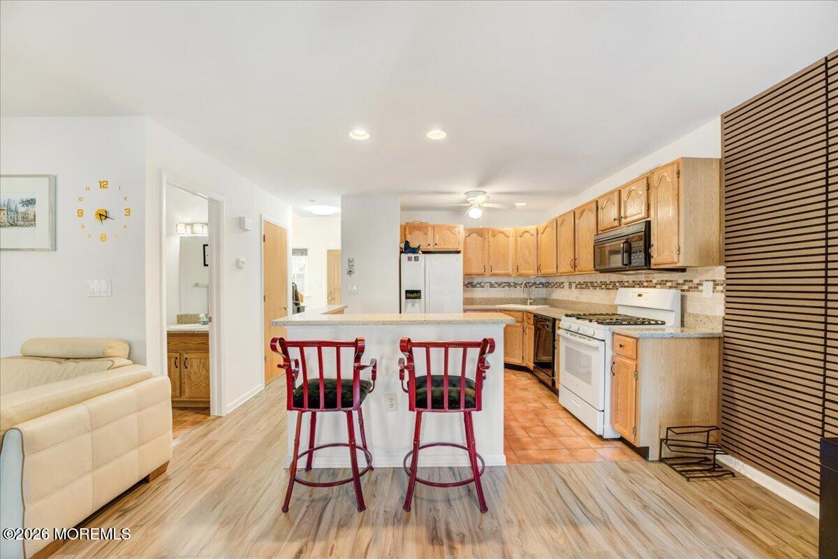 46 Stony Hill Road Jamesburg, NJ 08831 - Photo 10 of 23 a kitchen with stainless steel appliances granite countertop a stove top oven a sink dishwasher a dining table and chairs with wooden floor